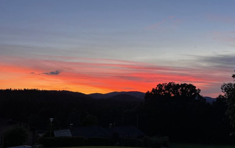 Traumhafte Sonnenuntergänge Sonnenuntergang mit lebhaften orange- und rosa Farbverläufen über den Bergen.